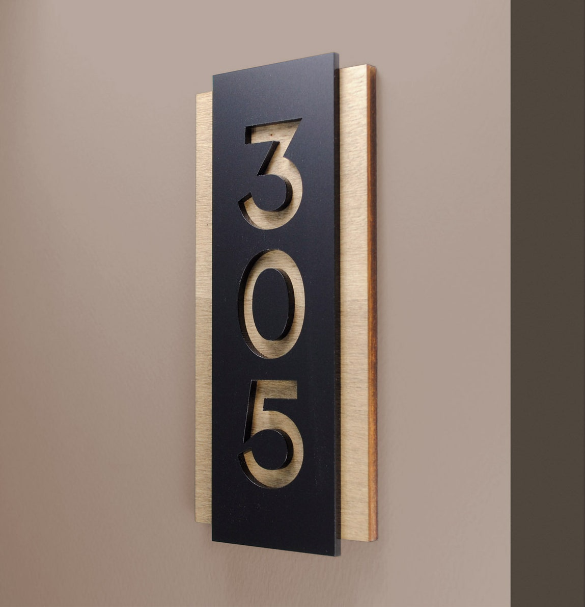 Unit 305 placard in powder-coated aluminum on maple.