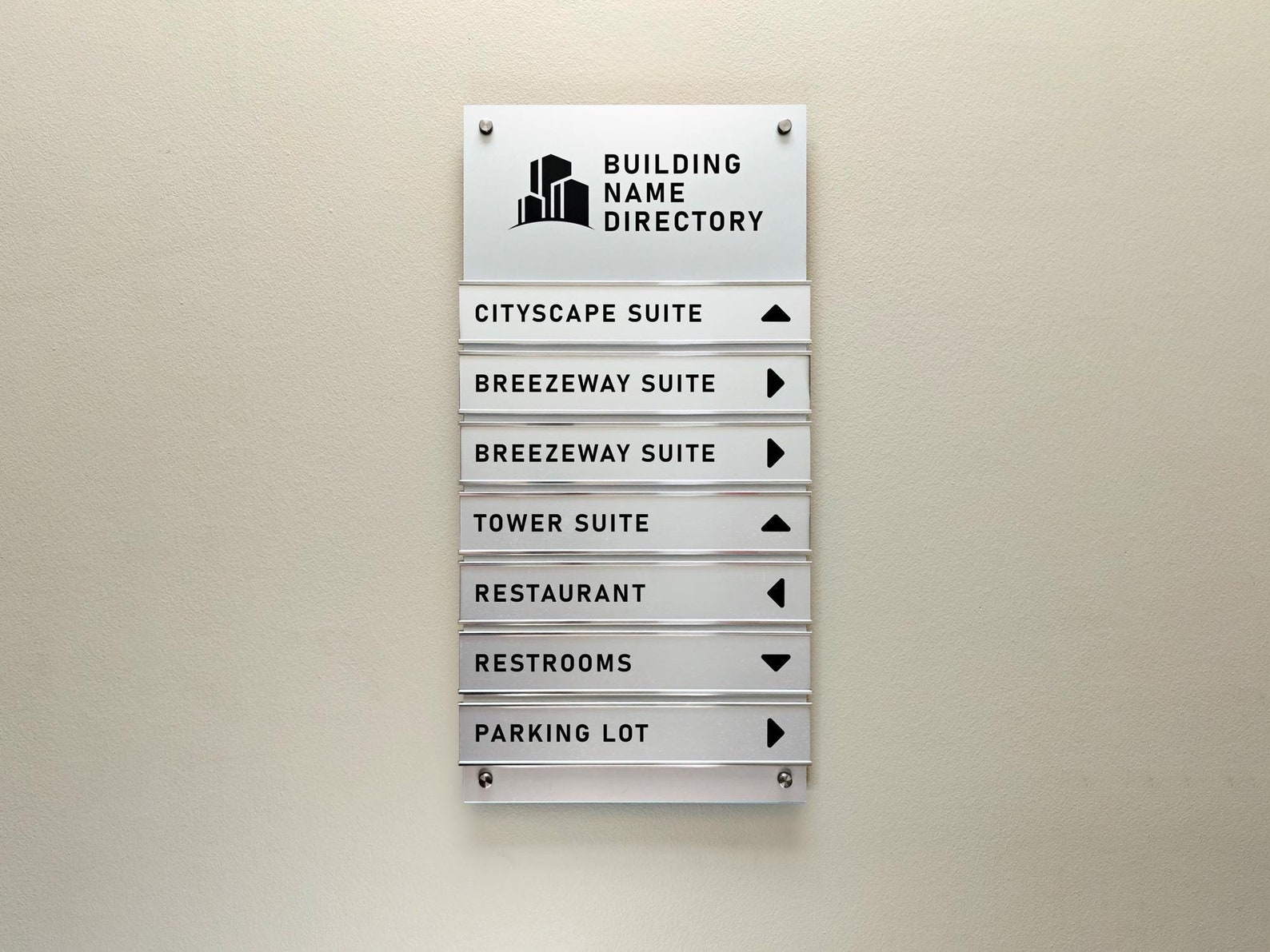 Exterior building directory with directional arrows and department listings — powder-coated aluminum panel on a post-mount base.